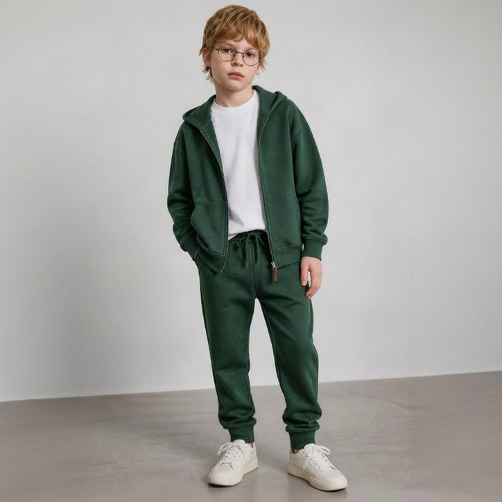 Boy in glasses wearing a forest green zip hoodie and drawstring joggers
