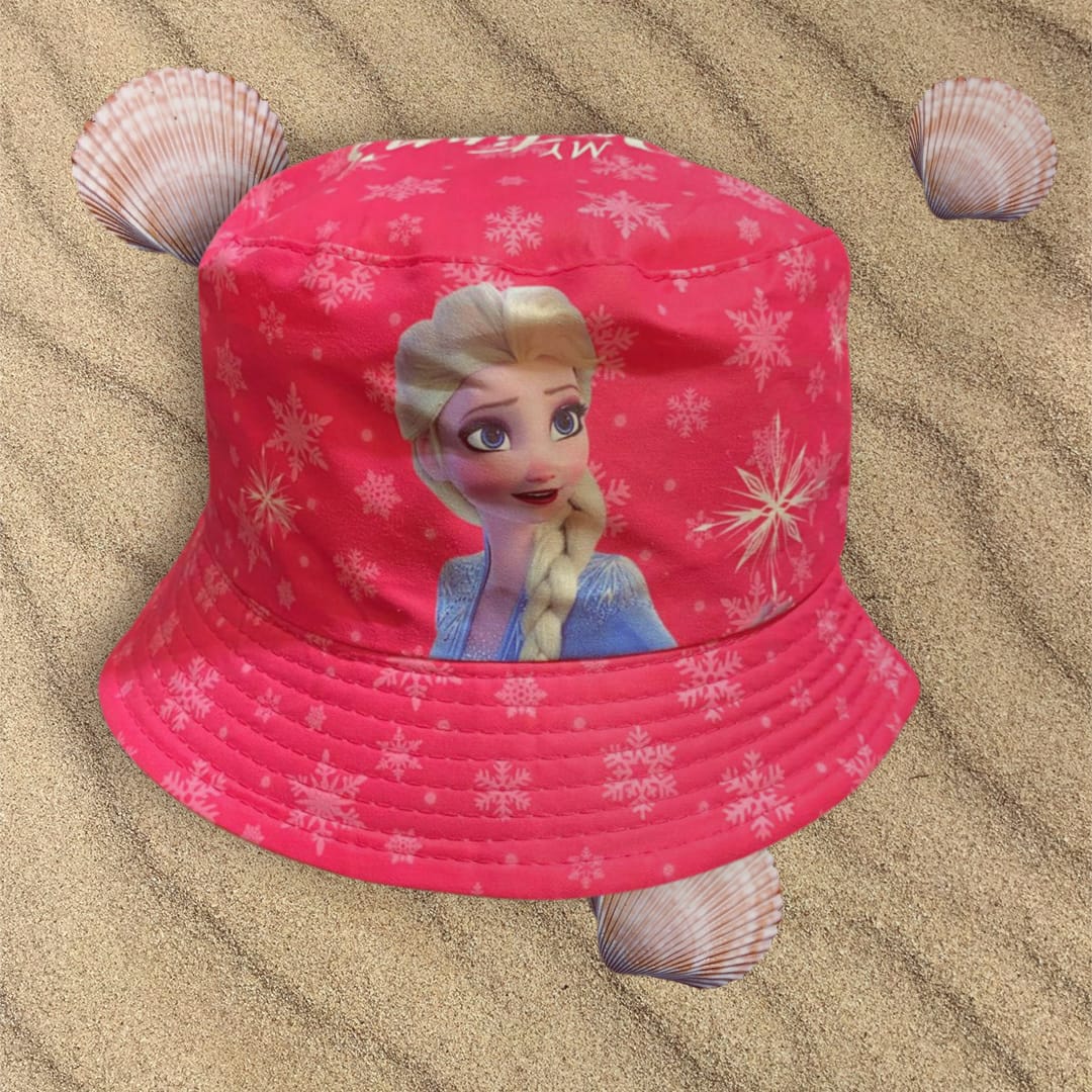 Bright cerise snowflake print bucket hat showing Elsa on the front panel, placed on sand