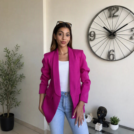 Bright fuchsia blazer with a sharply padded shoulder and strong tailored line