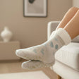 Cream fuzzy socks with a pale blue drop print and fluffy cuffs