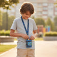 Boy wearing a blue gamer lanyard wallet on a neck strap and opening it outdoors