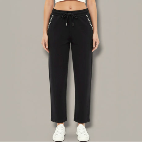 Black pants with white trim worn by a person on a gray background