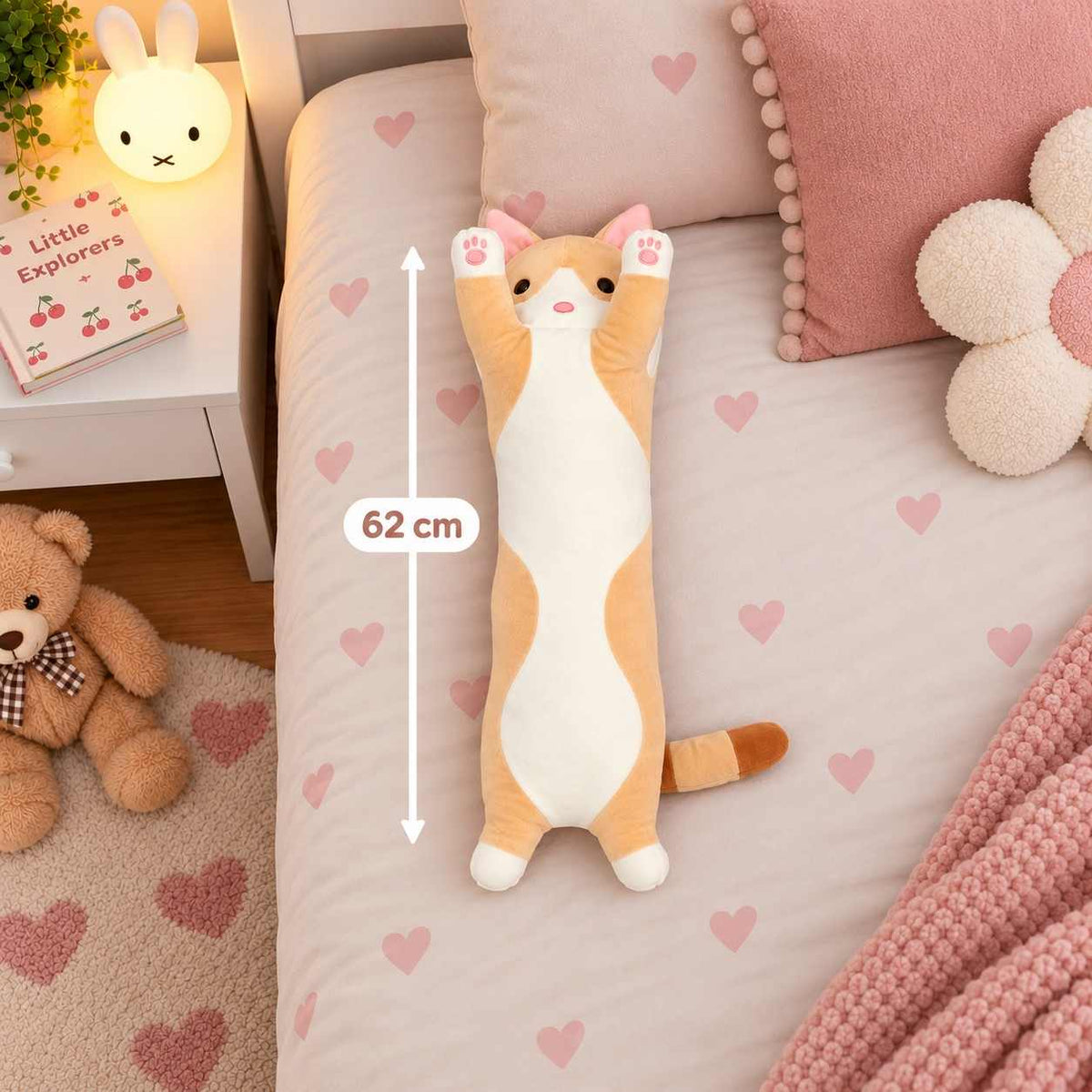 Ginger long cat body pillow plush lying on a heart print bed next to a 62 cm measuring line