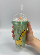 Giraffe print cup held in a hand showing the pastel beads inside the dome lid