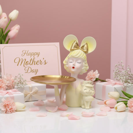 Ivory figure with gold mouse ears and her Love block cat, tulips and boxes around her