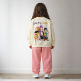 Back view of a cream girls sweatshirt with three Huntrix singers print above pink joggers