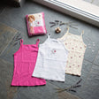 Three girls camisole vests in pink, white and a cream floral and heart print