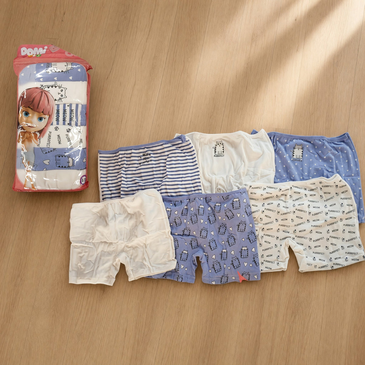 Six lilac and white girls boxer shorts with cat, heart, star and Meow prints laid out beside their pack