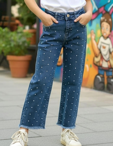 Blue denim jeans with pearl studs styled with white sneakers