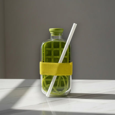 Olive green glass drink bottle with a grid chiller insert and a yellow silicone sleeve