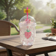 Glitter tumbler with a pink strawberry print, a bear charm and a yellow flower straw topper
