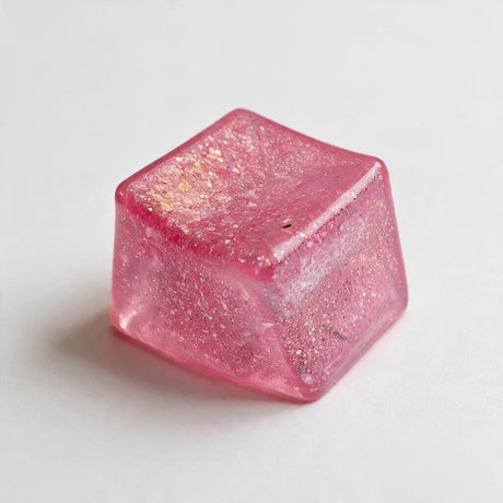 Pink glitter jelly cube squishy with a translucent sparkly finish