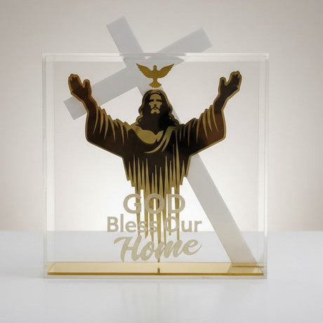 Gold figure of Christ with arms raised beneath a dove, lettered God Bless Our Home