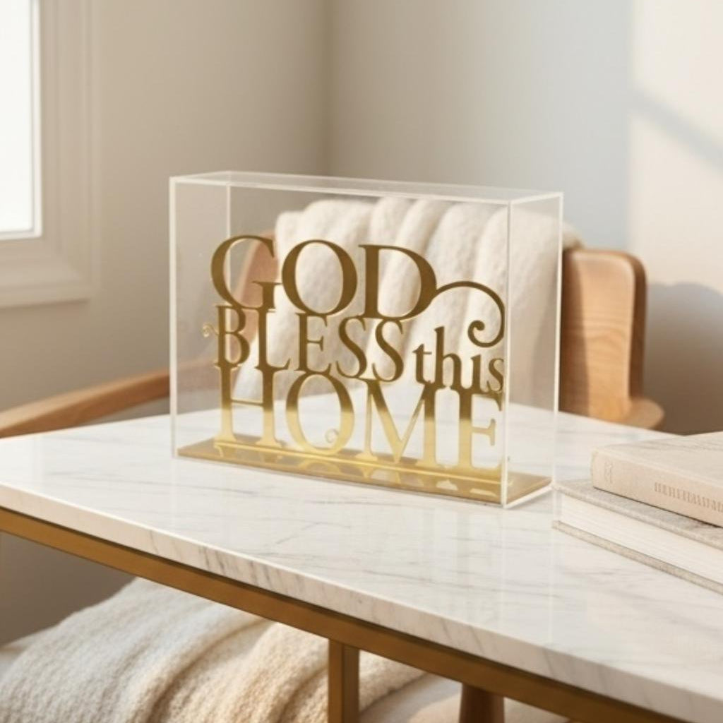 Mirrored gold cut lettering reading God Bless this Home inside a clear acrylic case