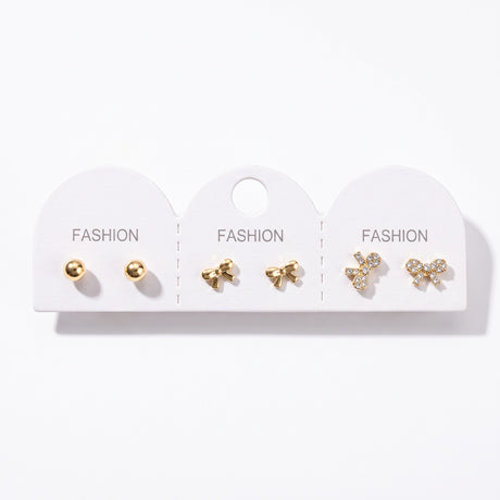 Gold ball studs with a plain bow pair and a crystal pave bow pair on one card