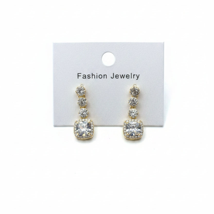 Pair of gold earrings on a 'Fashion Jewelry' card against a white background