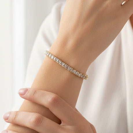 Gold square bracelet with clear stones worn by a person