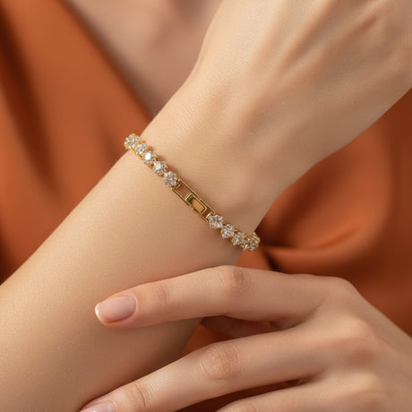 Gold bracelet with clear stones on a person's hand