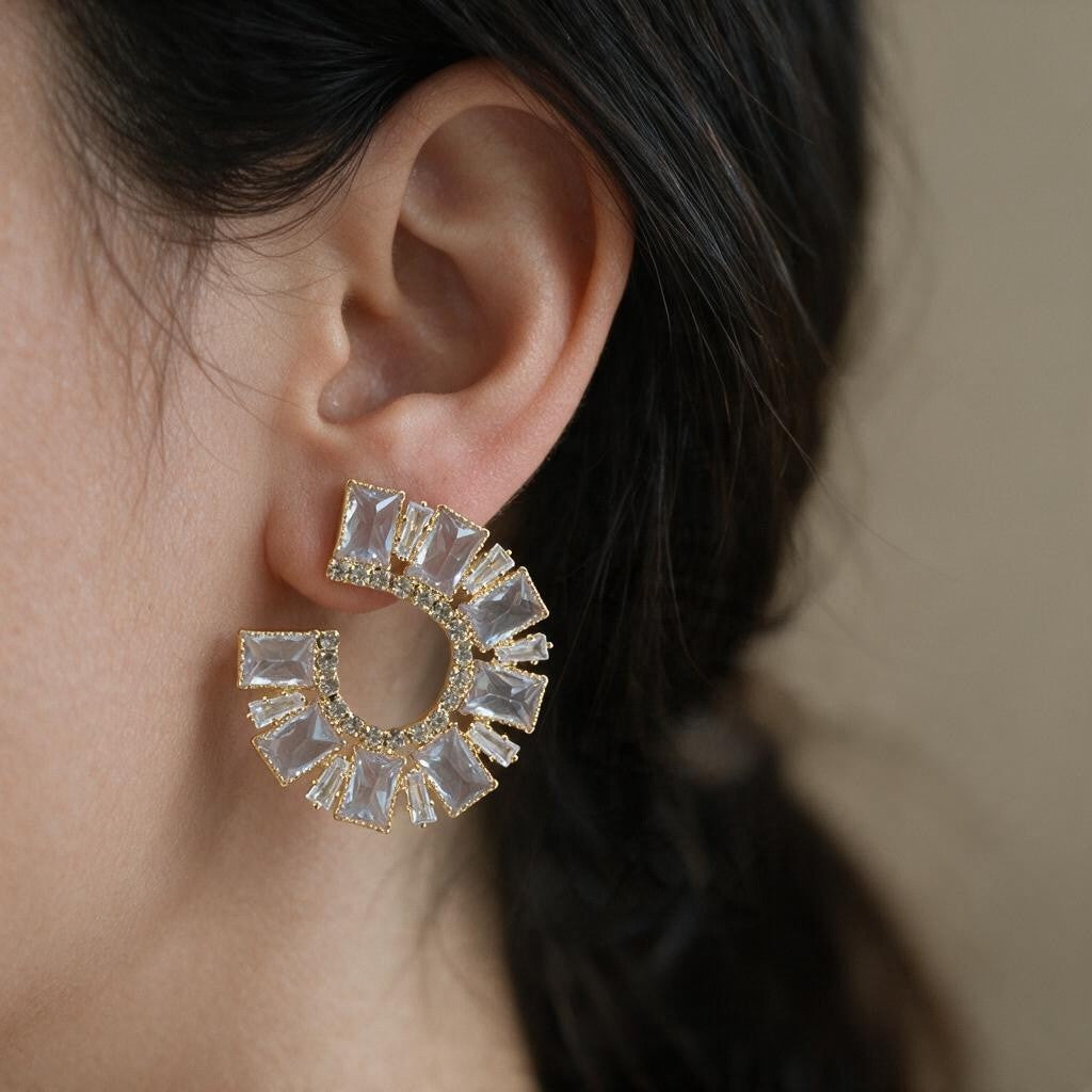 Gold crescent earring set with large emerald cut crystals worn on the ear