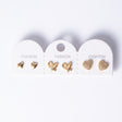 Three pairs of gold heart stud earrings on a card, polished, open and pave set
