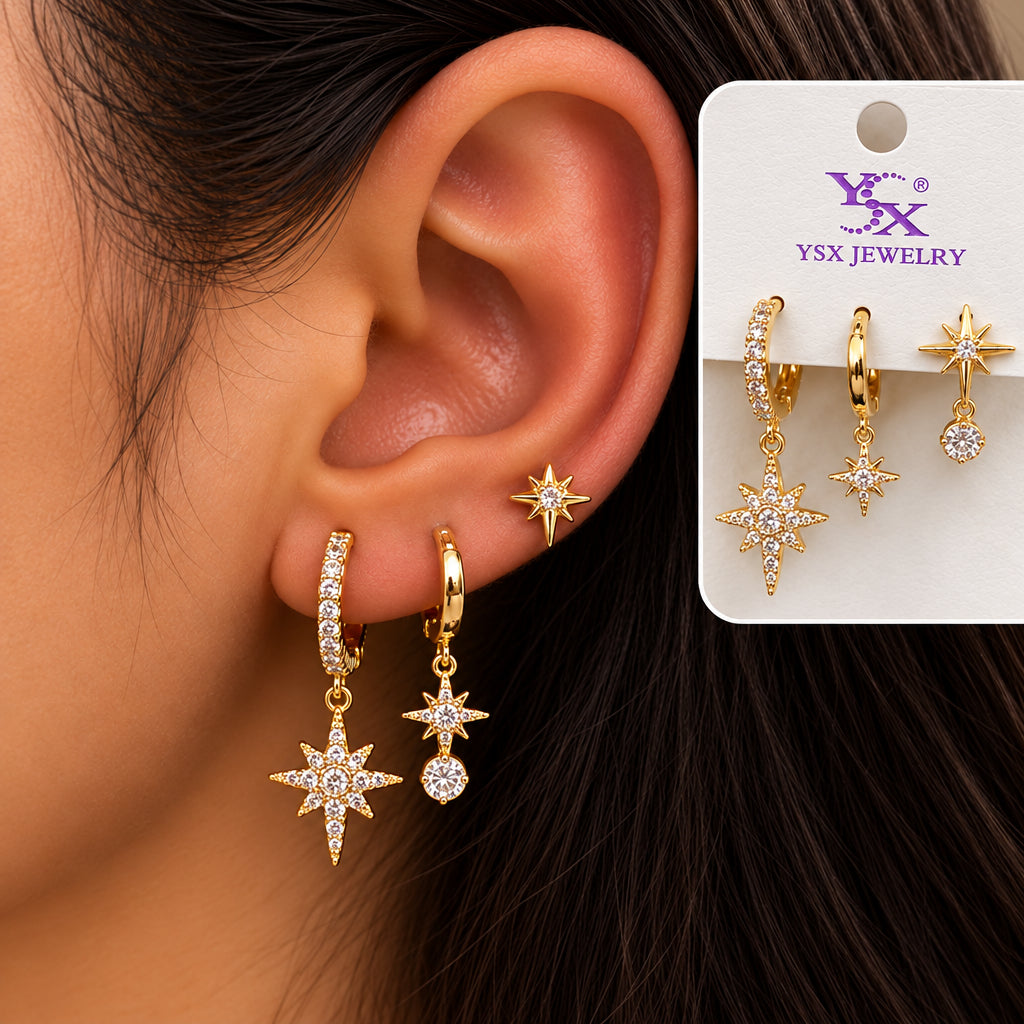 Ear wearing a large crystal north star hoop, a small star huggie and a star stud with a crystal drop