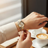Two tone bracelet and fluted bezel detail on women's gold tone watch
