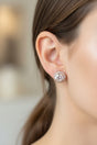 Close-up of a person wearing a sparkling earring with a blurred background