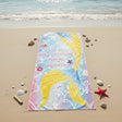Golden mermaid tail beach towel on a pastel rainbow scallop scale print