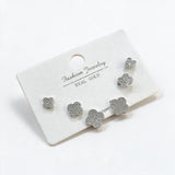 Silver pave crystal clover studs in three graduated sizes on a white display card