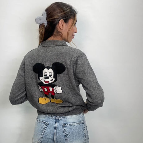 Grey knit cardigan seen from behind, showing the embroidered cartoon character back