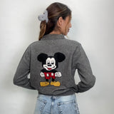 Back view of a grey collared cardigan with a large cartoon mouse patch