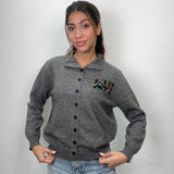 Grey melange knit cardigan with a polo collar, black buttons and a small chest patch