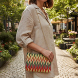 Green chevron tapestry crossbody bag worn over a linen shirt