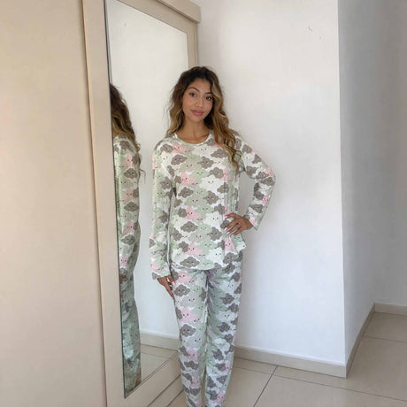 Smiling cloud motifs scattered across a cream long sleeve sleepwear set