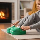 Child putting on a green crocodile slipper beside a fireplace