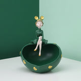The green heart bowl on a forest and mint studio corner, gold heart studs catching light