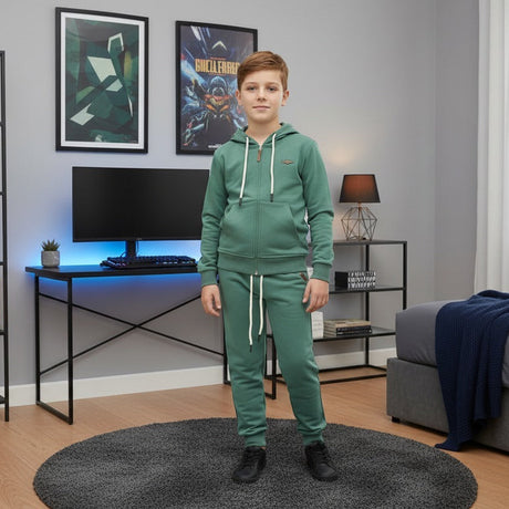 Green zip up hoodie and jogger two piece set worn by a boy in a bedroom