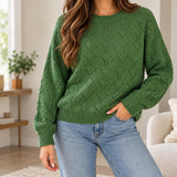 Green pointelle crew neck sweater with an open chevron knit, worn with light blue jeans