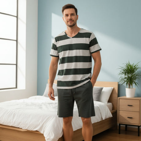 Man wearing a green and grey striped tee with dark green shorts