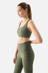 Woman wearing a green athletic outfit on a white background
