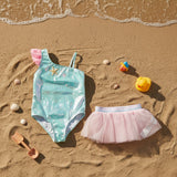 Green starfish swimsuit and tulle skirt flat lay with shell props