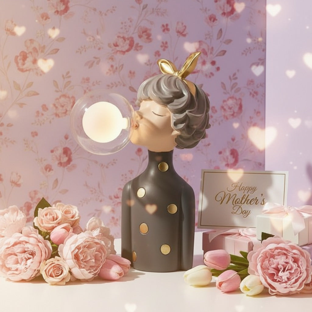 Charcoal figure with gold spots, her lit glass globe glowing against floral wallpaper
