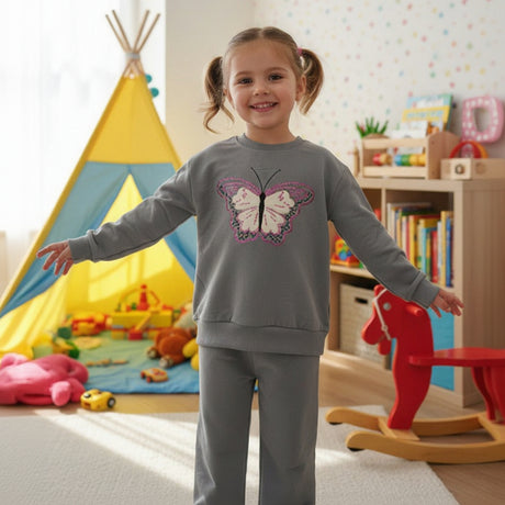 Girl in a grey sweatshirt with an embroidered butterfly and matching pants