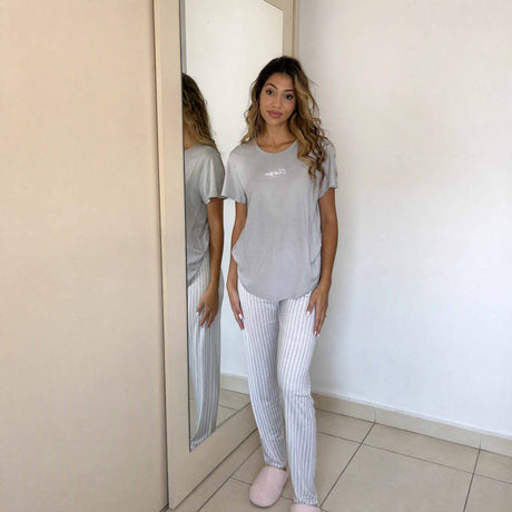Soft grey top and vertical stripe trousers shown as a full sleepwear set