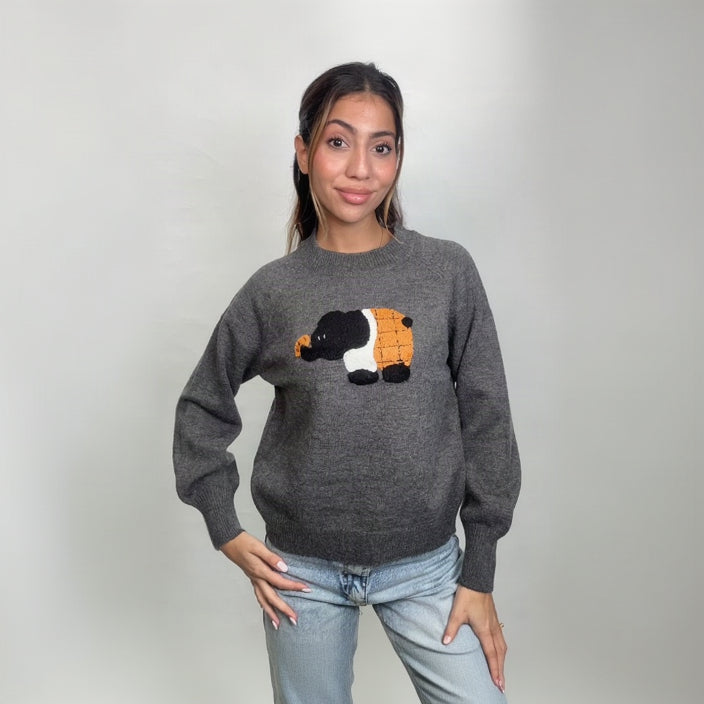 Grey raglan sleeve sweater with an elephant applique, worn with light wash jeans