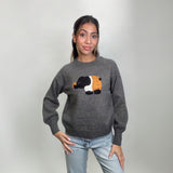Grey raglan sleeve sweater with an elephant applique, worn with light wash jeans