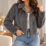 Grey faux fur jacket with a wide collar and four bronze buttons, worn open over a white tank