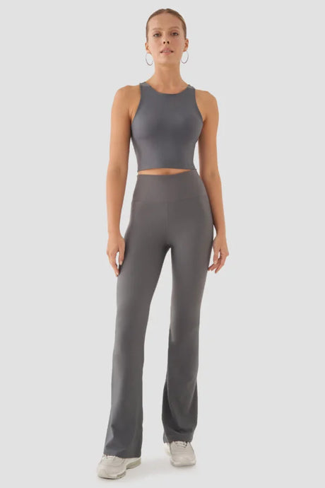 Person wearing a grey athletic outfit on a white background