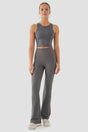 Woman wearing a grey athletic outfit on a white background