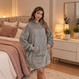 Grey hooded blanket in soft fleece with a front pocket and dropped shoulders
